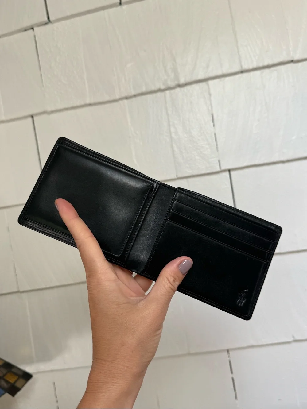 Polo Ralph Lauren bi-fold leather wallet in black featuring a debossed logo